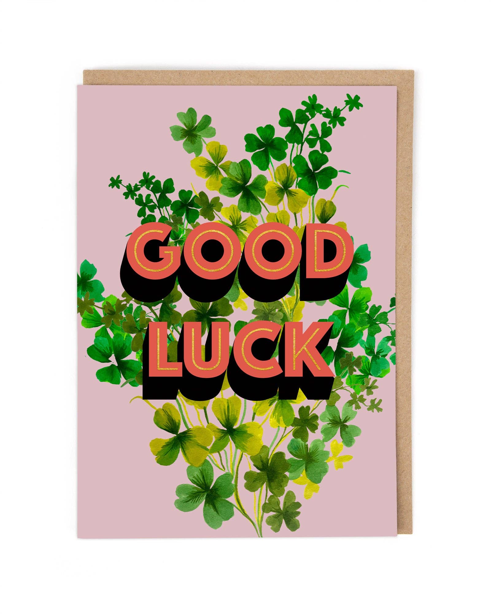 Greeting card with 'Good Luck' text surrounded by shamrocks on a pink background