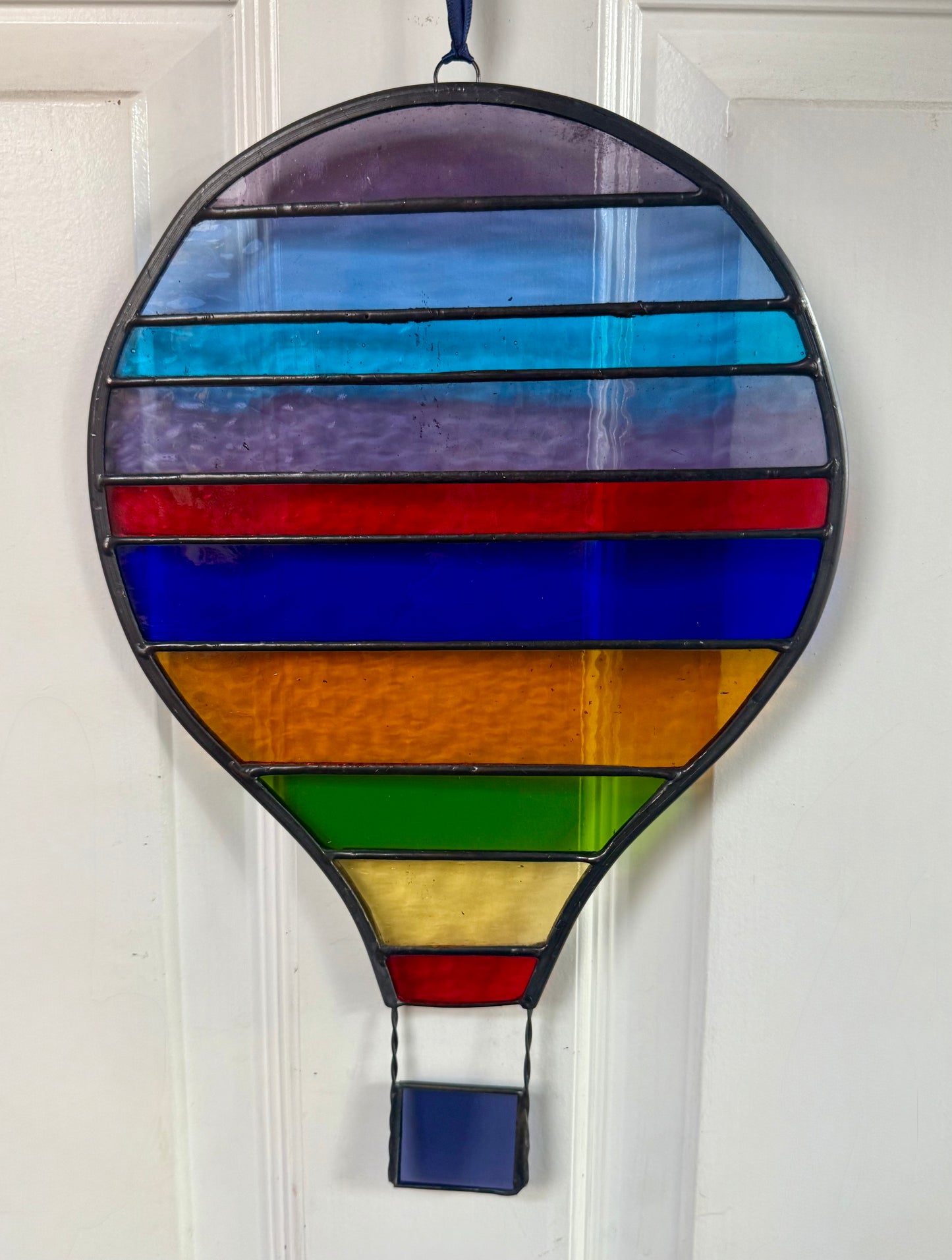 Stained glass hot air balloon suncatcher with stripes.