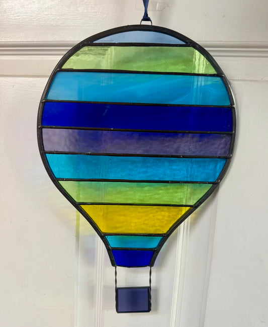 Stained glass hot air balloon suncatcher with stripes.