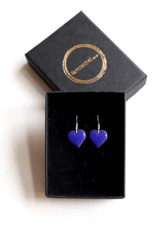 Small blue heart shaped enamel earrings with sterling silver hoops.