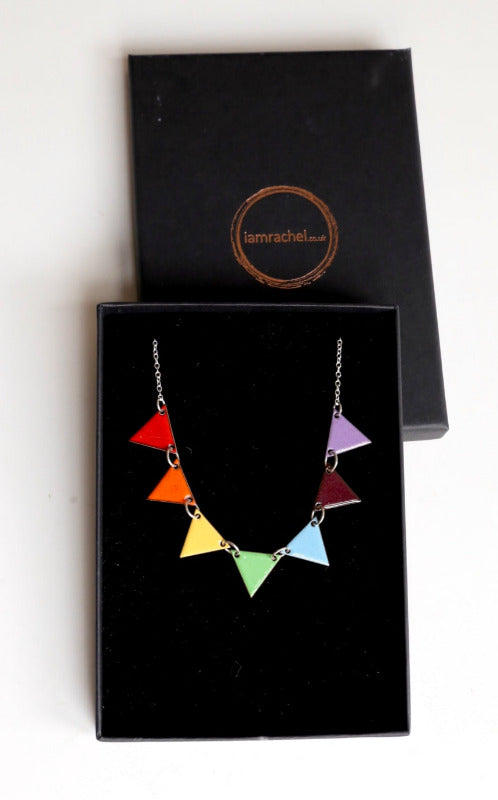 Enamel necklace with seven triangles of individual colours of the rainbow on a sterling silver chain