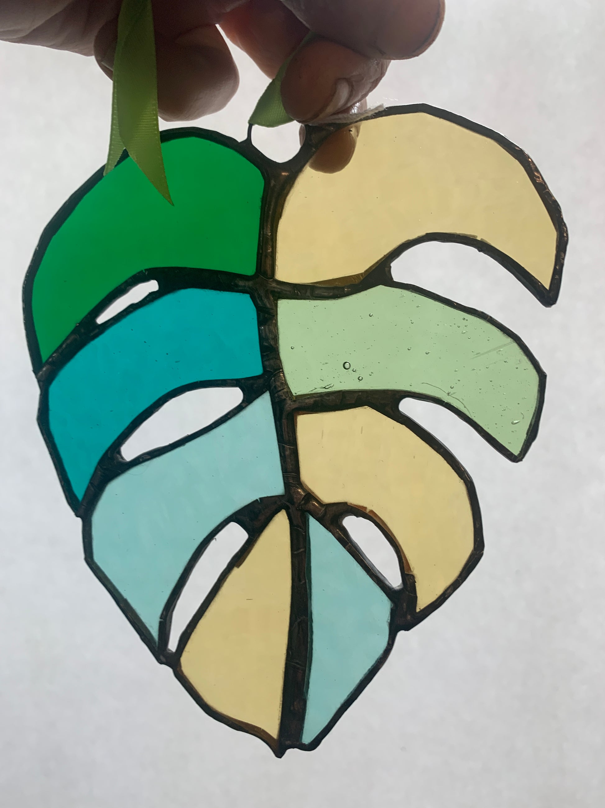 Stained Glass sun catcher.  Monstera Leaf.  Dadswell Glass studio based in Bristol.