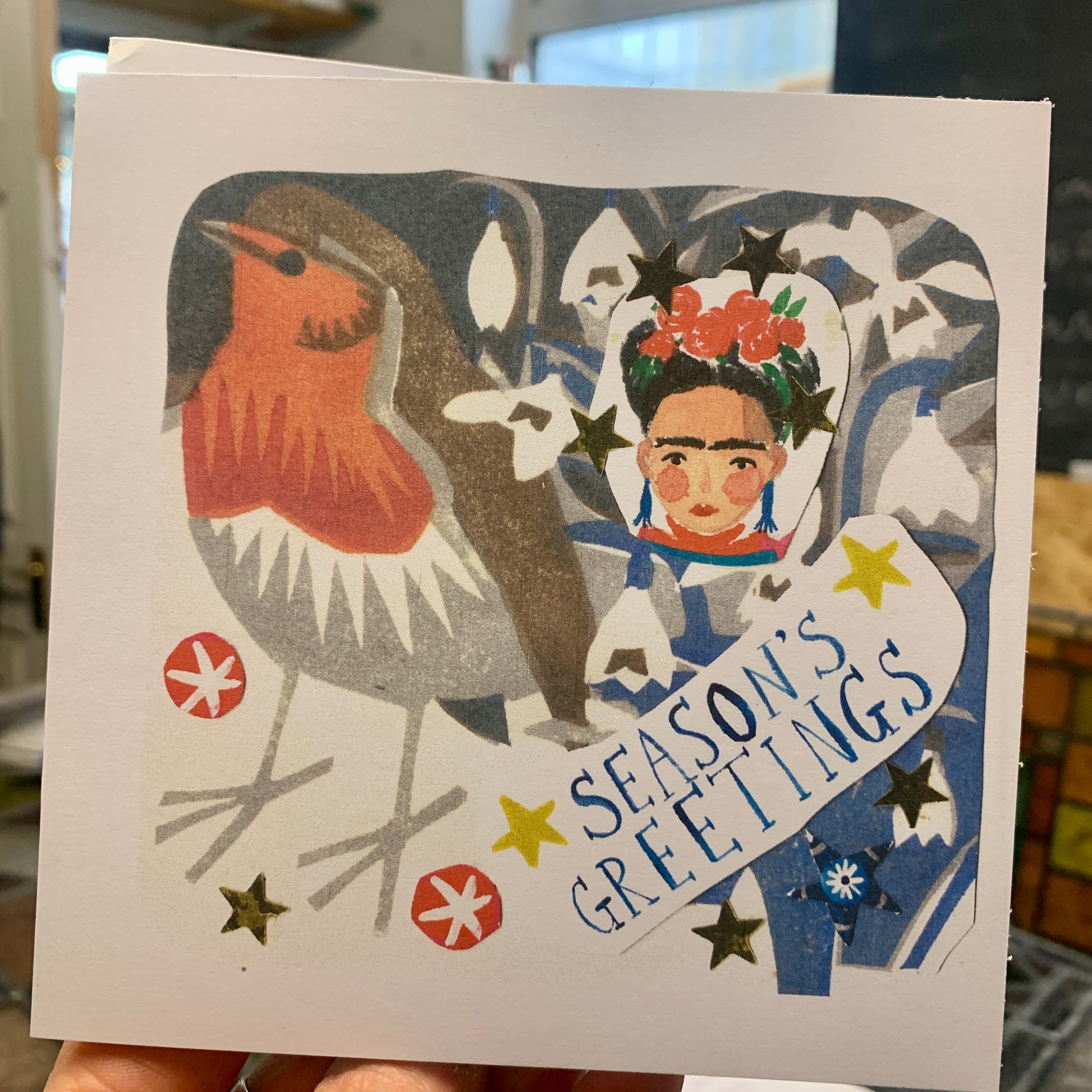 A collage image of Frida and robin with seasons greetings card
