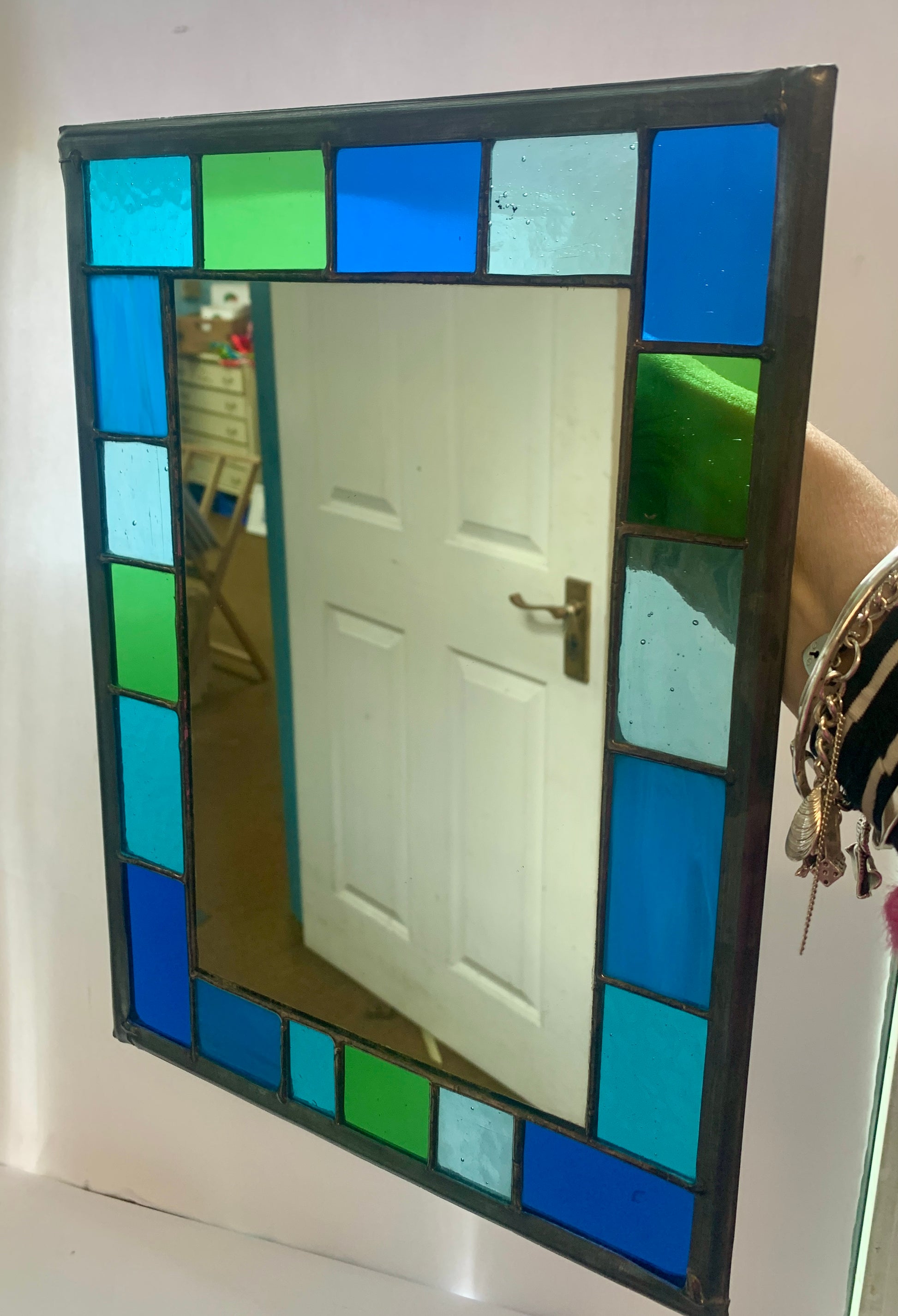 Stained Glass Mirror with randomly placed blue and green glass border.