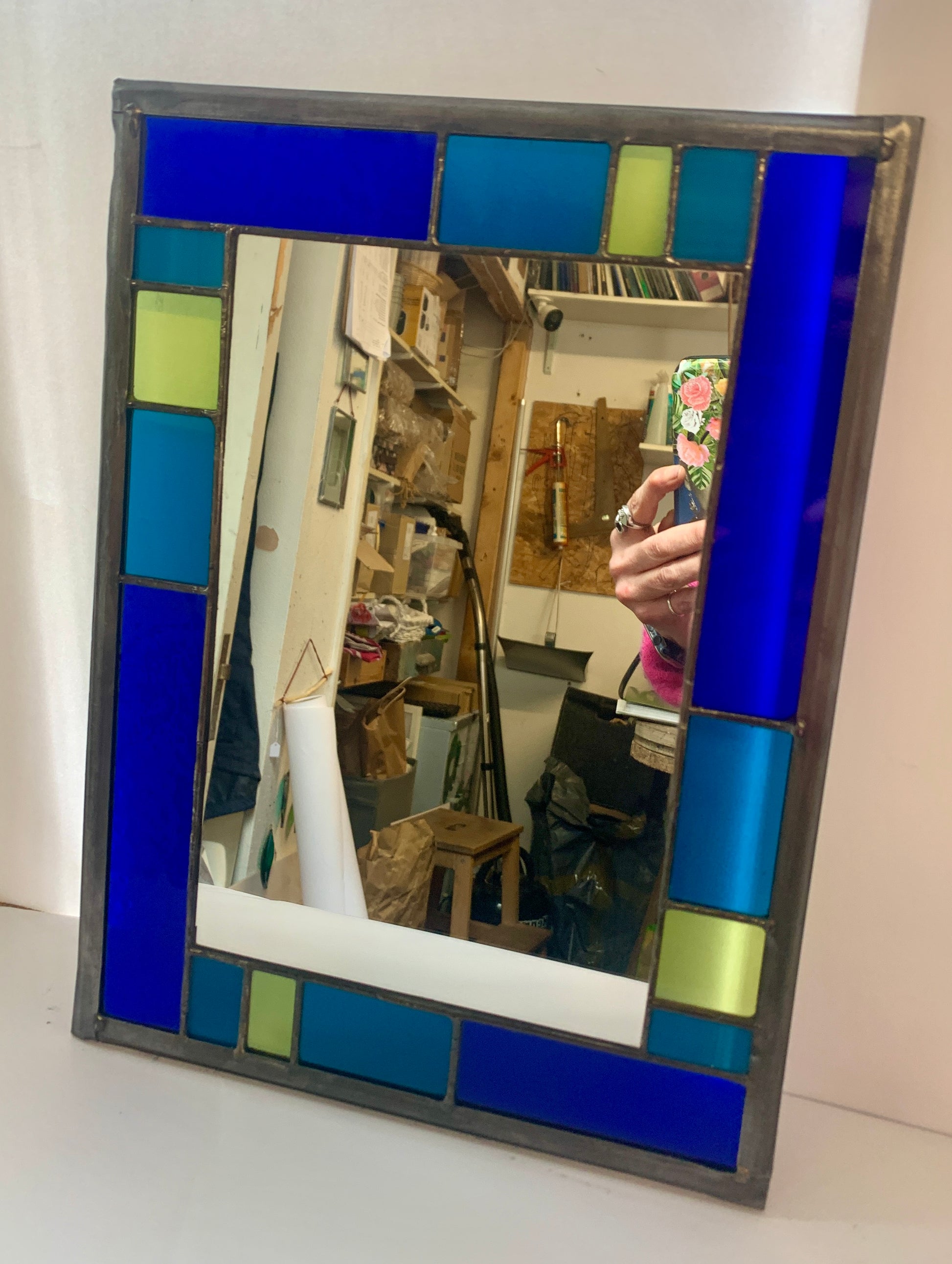 Stained Glass Mirror with randomly placed blue and green glass border.