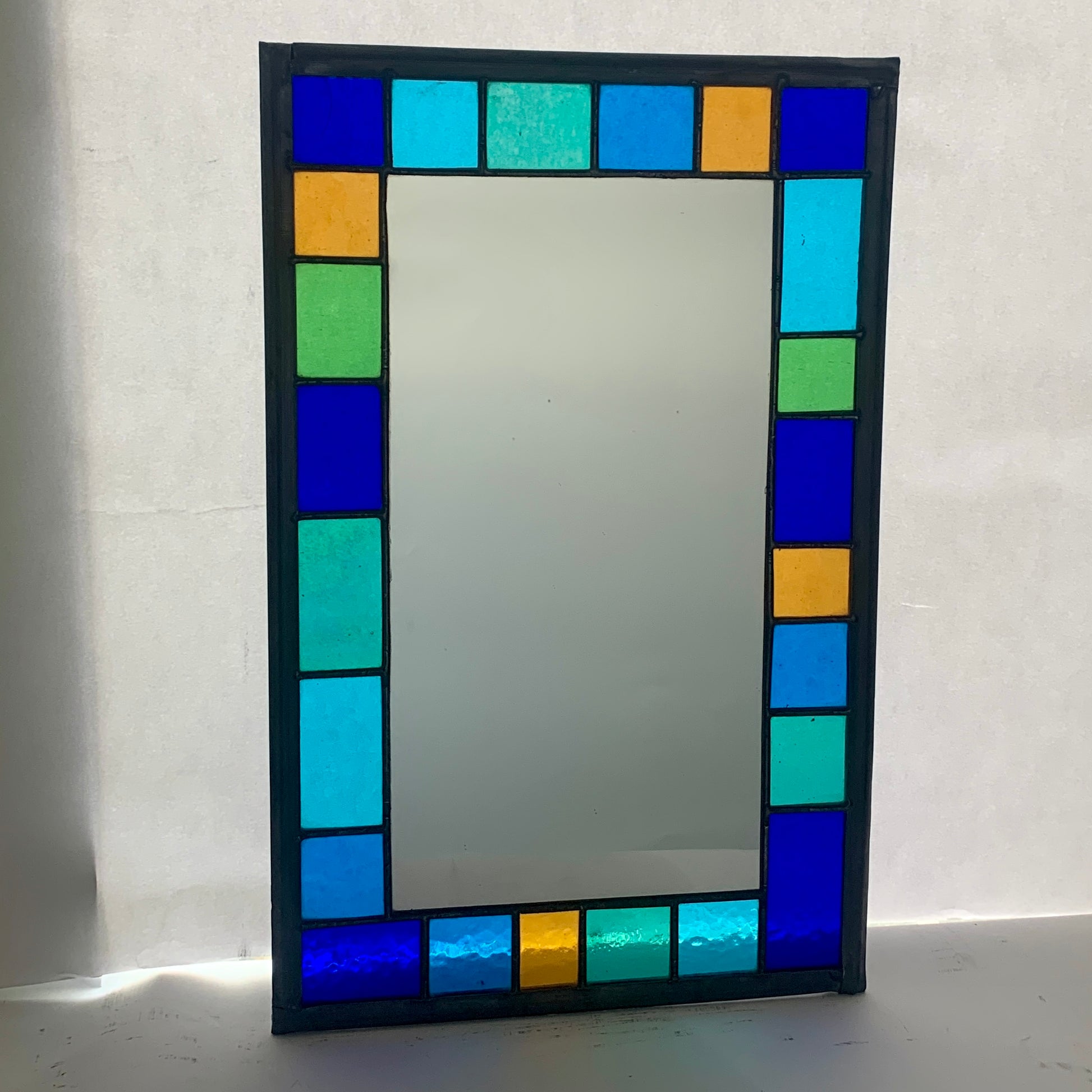 Stained Glass Mirror with randomly placed blue and green glass border. Stained Glass. Traditional Colour Glass. Blues, Aqua and Turquoise Glass.