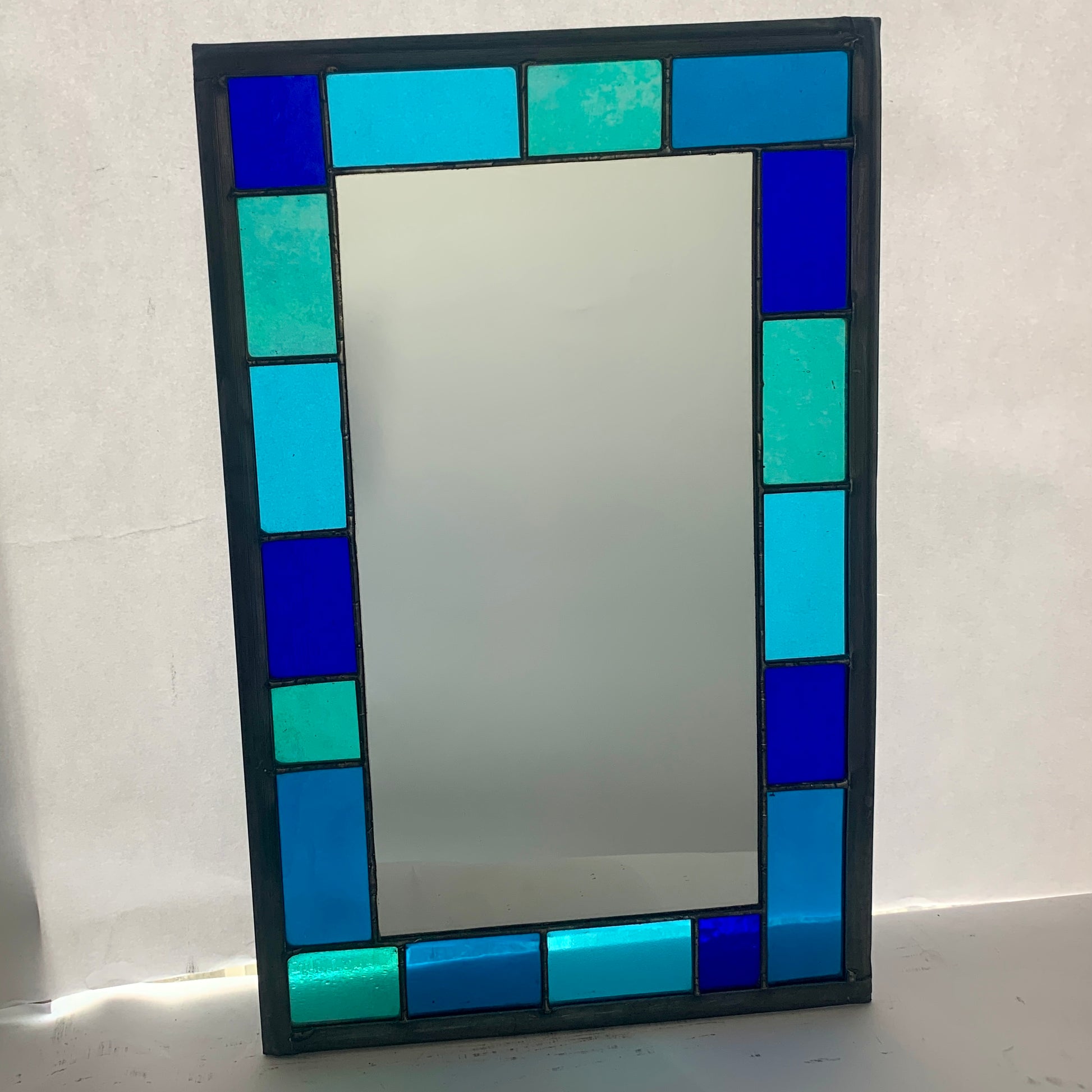 Stained Glass Mirror with randomly placed blue and green glass border. Stained Glass. Traditional Colour Glass. Blues, Aqua and Turquoise Glass.