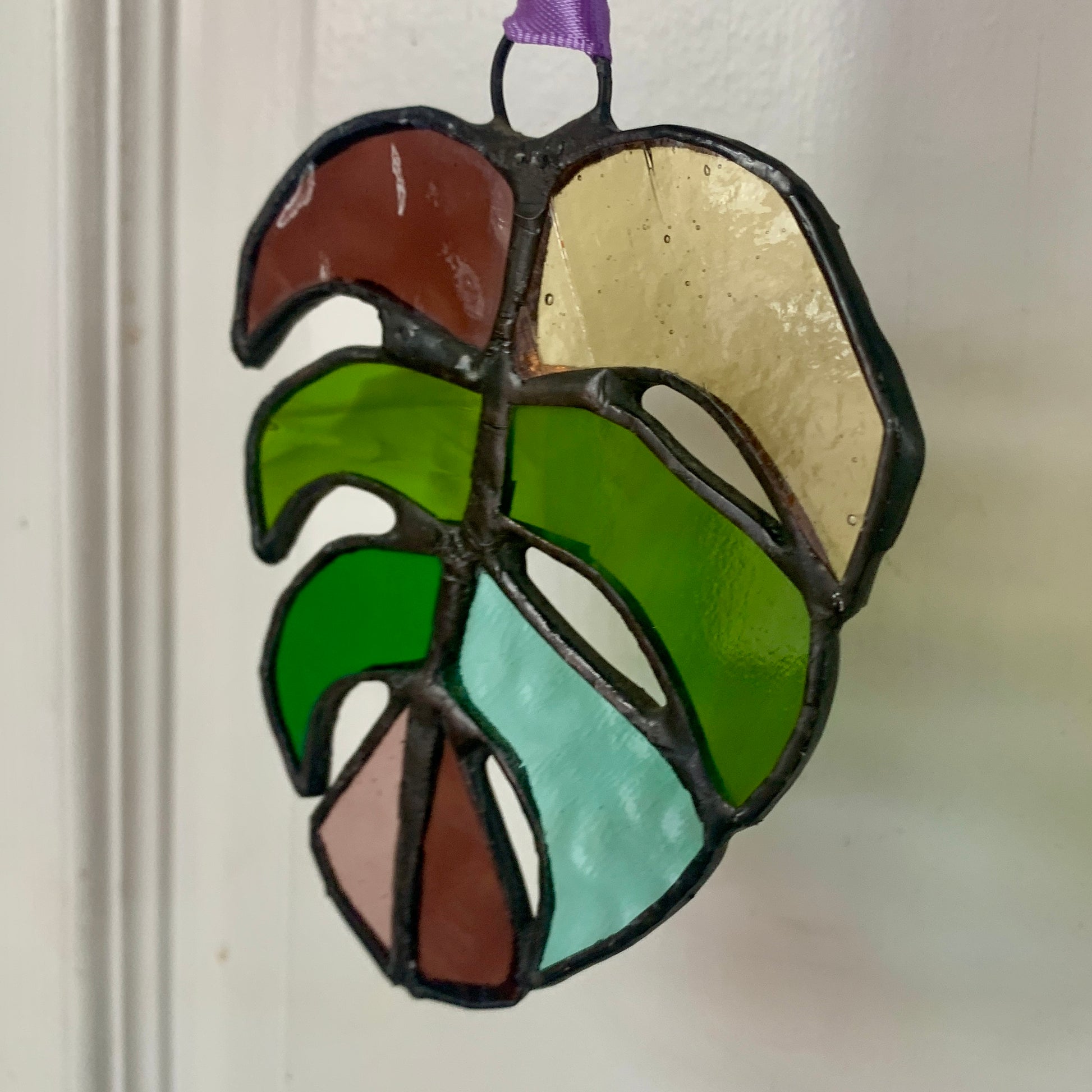 Stained Glass sun catcher. Monstera Leaf. Dadswell Glass studio based in Bristol.