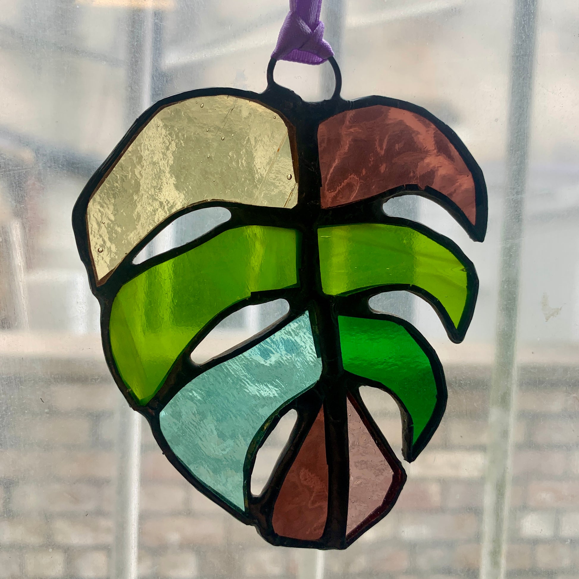 Stained Glass sun catcher. Monstera Leaf. Dadswell Glass studio based in Bristol.