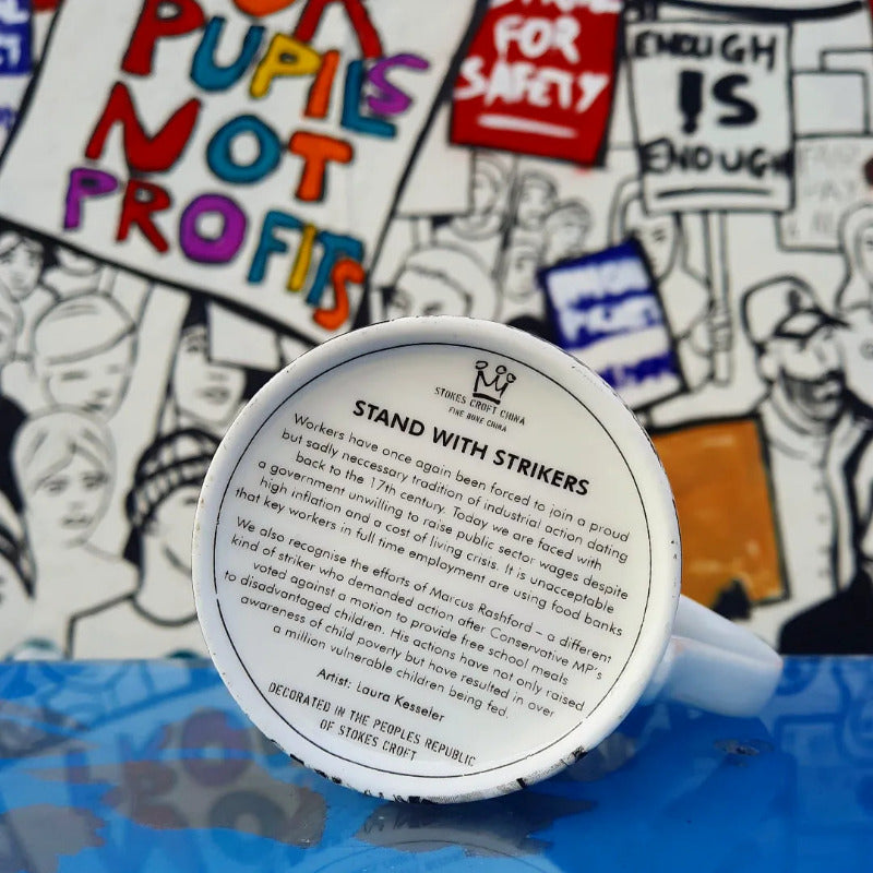 Base of mug with text about strikers and activism