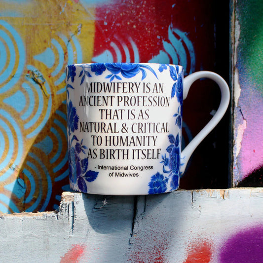 Bone china mug with blue rose pattern on white with text celebrating Midwifery.