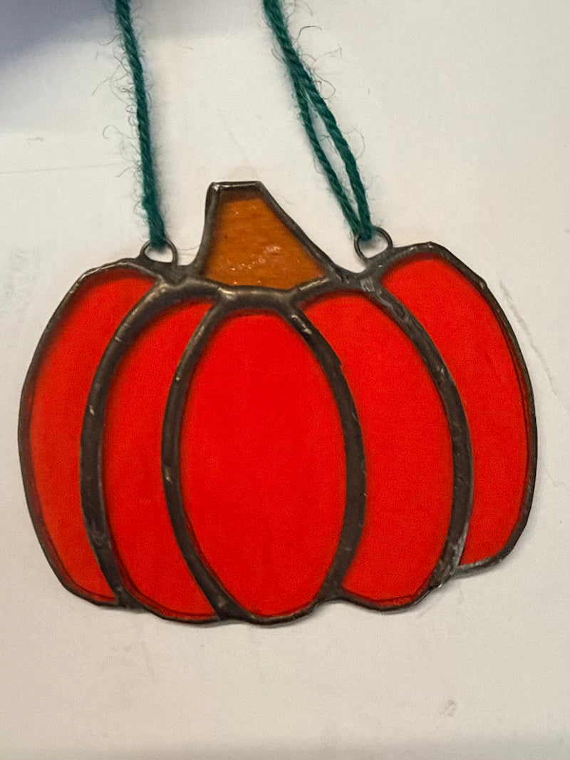 Orange glass pumpkin on a white background.