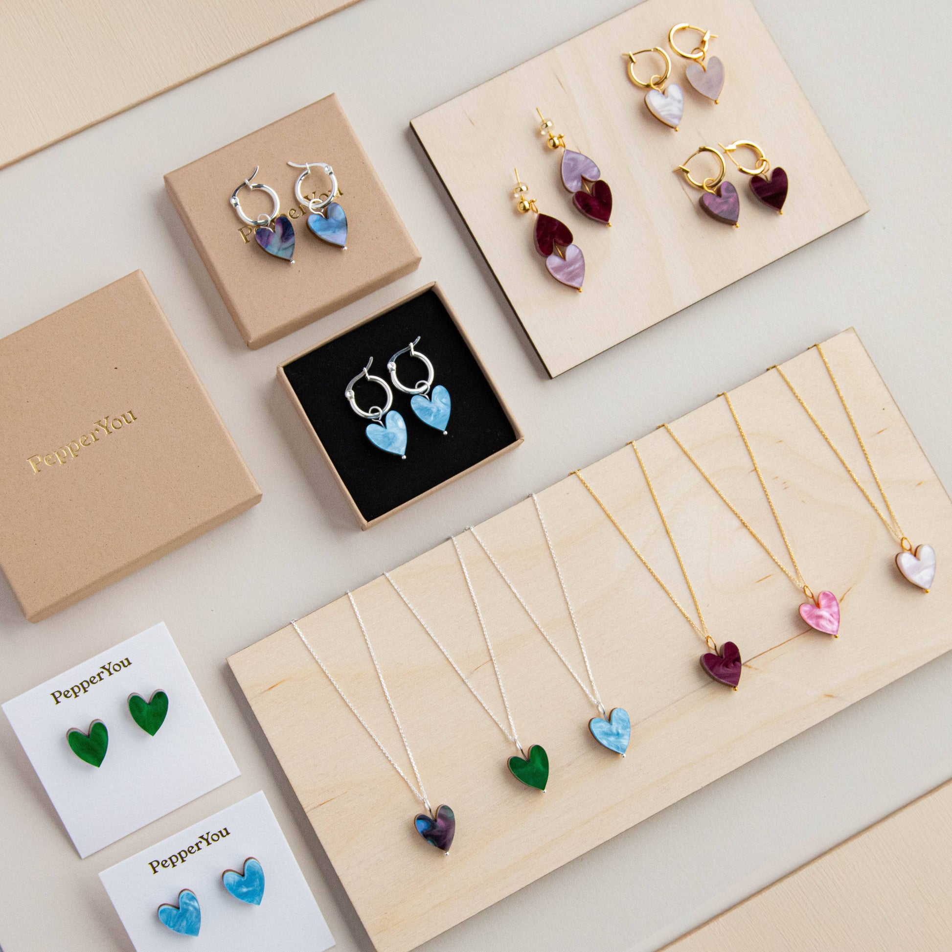 Jewelry set including earrings and necklaces on display with 'PepperYou' branding.