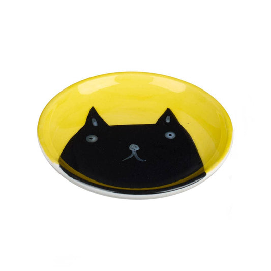 Yellow plate with a black cat face design on a white background