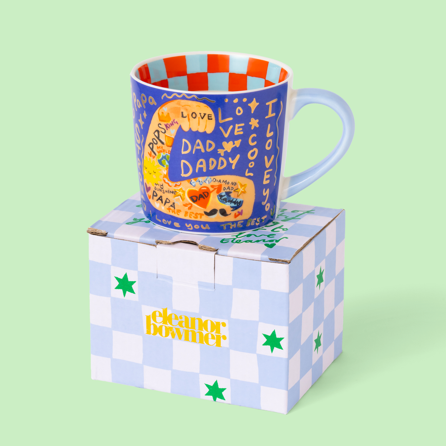 Blue mug on box on green background.