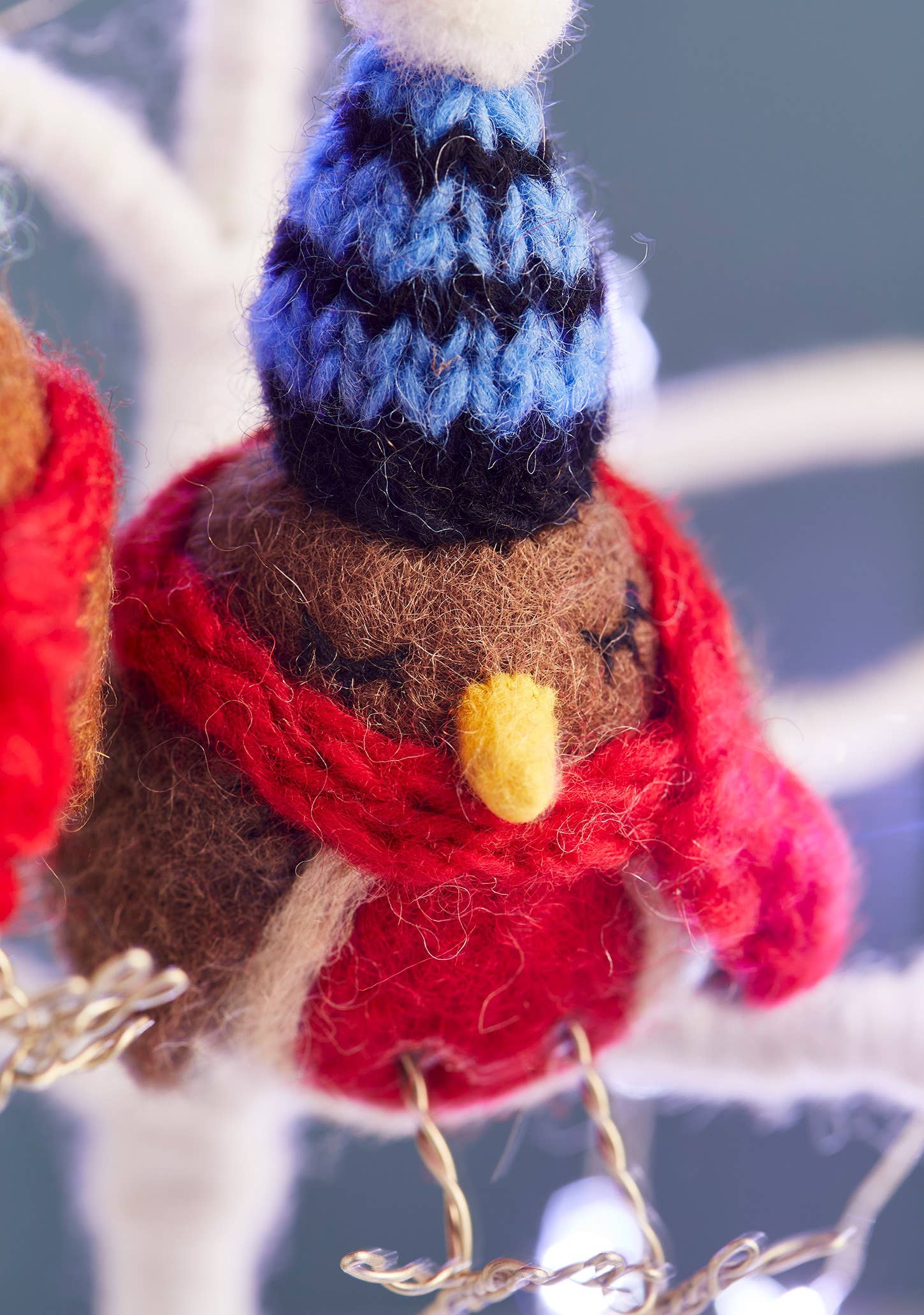 Felted robin with woolly hat and scarf.
