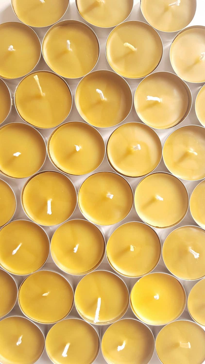 Grid of yellow candles in a metal container
