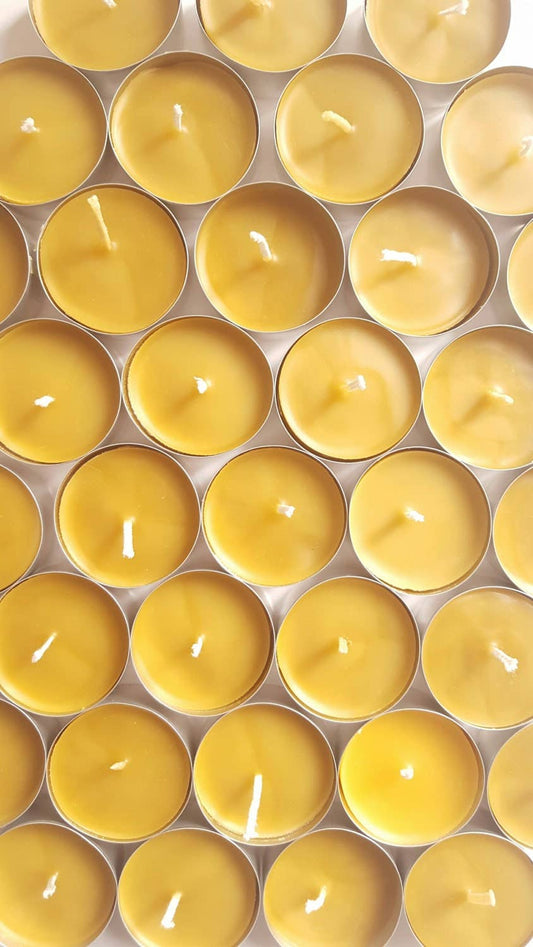 Grid of yellow candles in a metal container