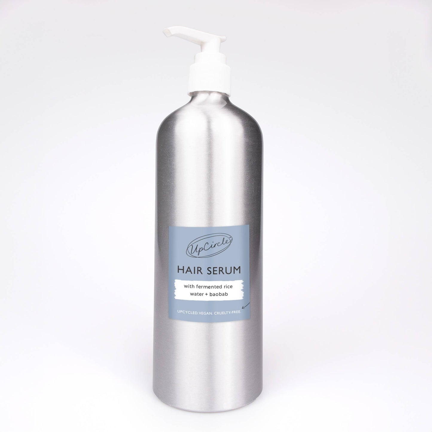 Silver bottle of scalp and hair oil with a blue label on a white background