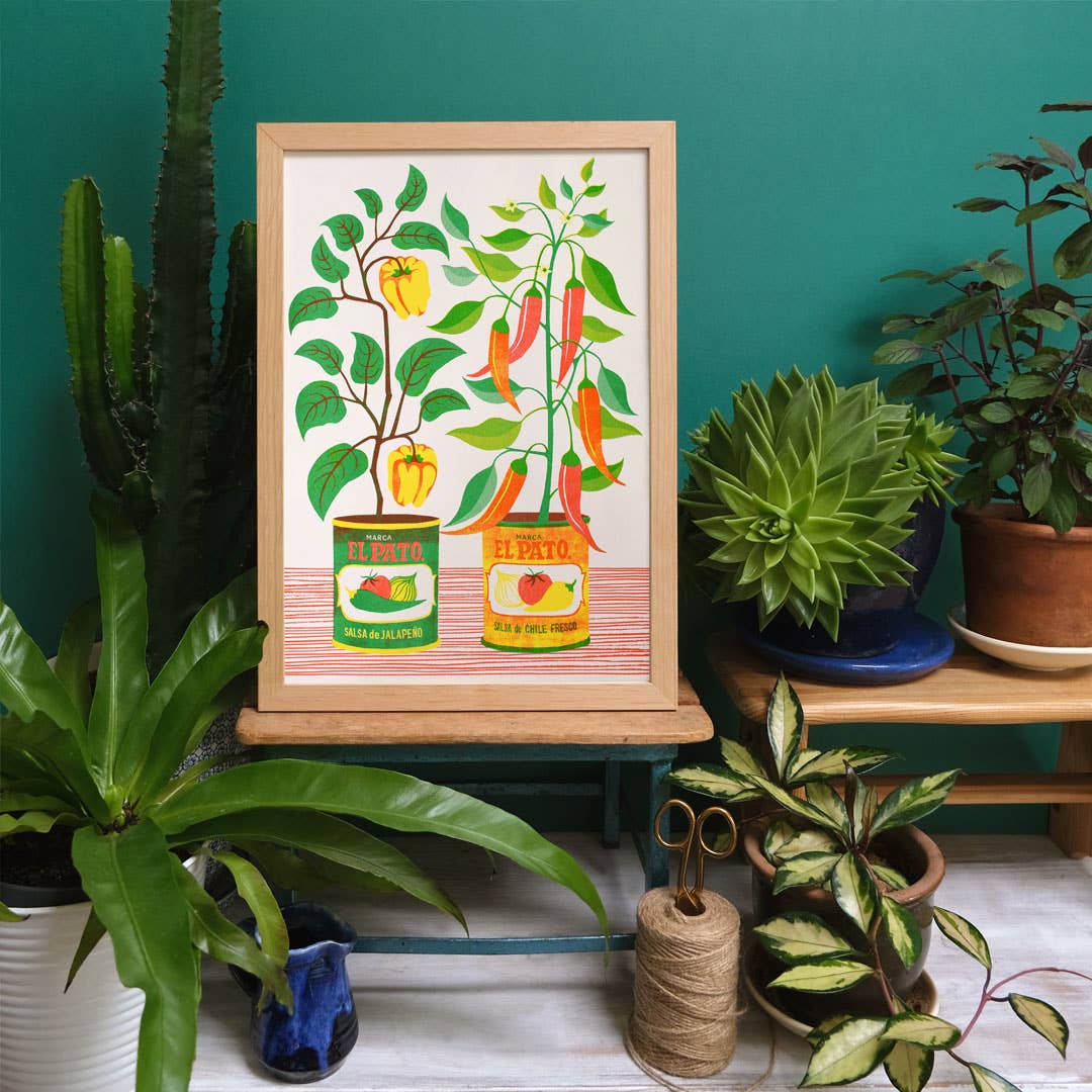 Risograph print of chillis growing in tins.