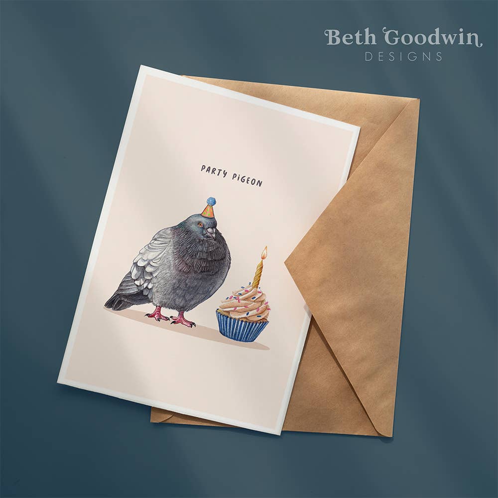 Greeting card with a pigeon and cupcake illustration and a brown envelope on a dark blue background.