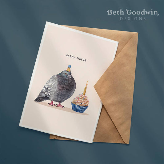 Greeting card with a pigeon and cupcake illustration and a brown envelope on a dark blue background.
