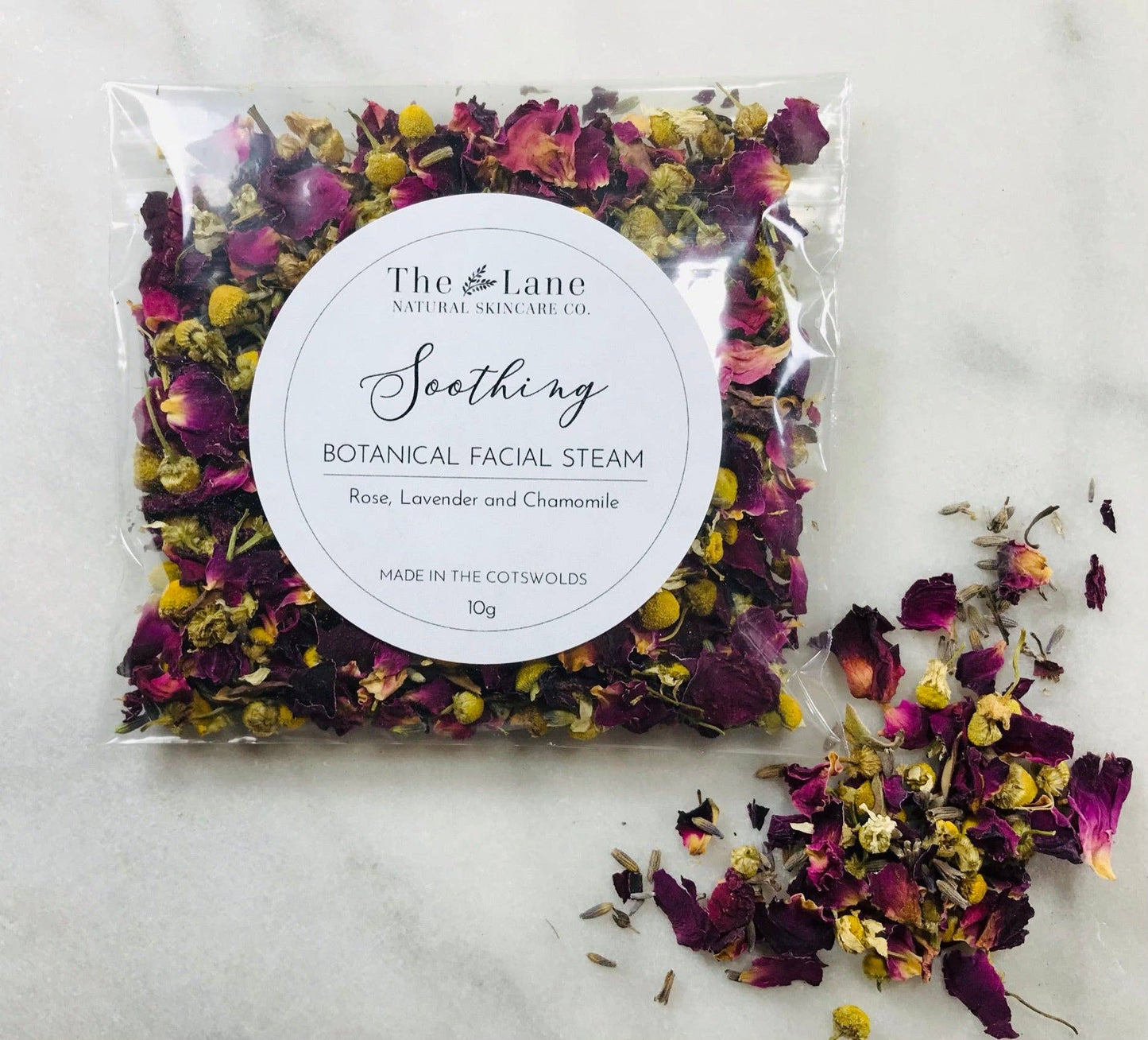 Packaged botanical facial steam with dried flowers on a light background