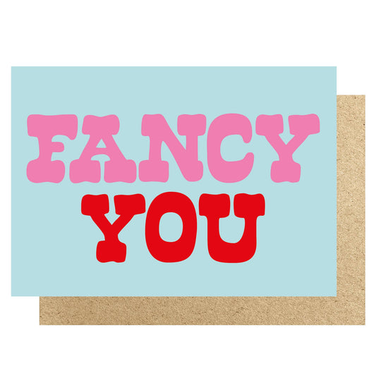 Greeting card with 'FANCY YOU' text in pink and red on a light blue background