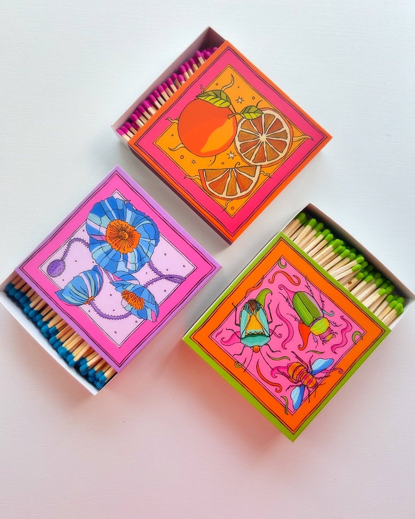 Matches in a beautifully box with illustration of oranges in colours of red and orange.