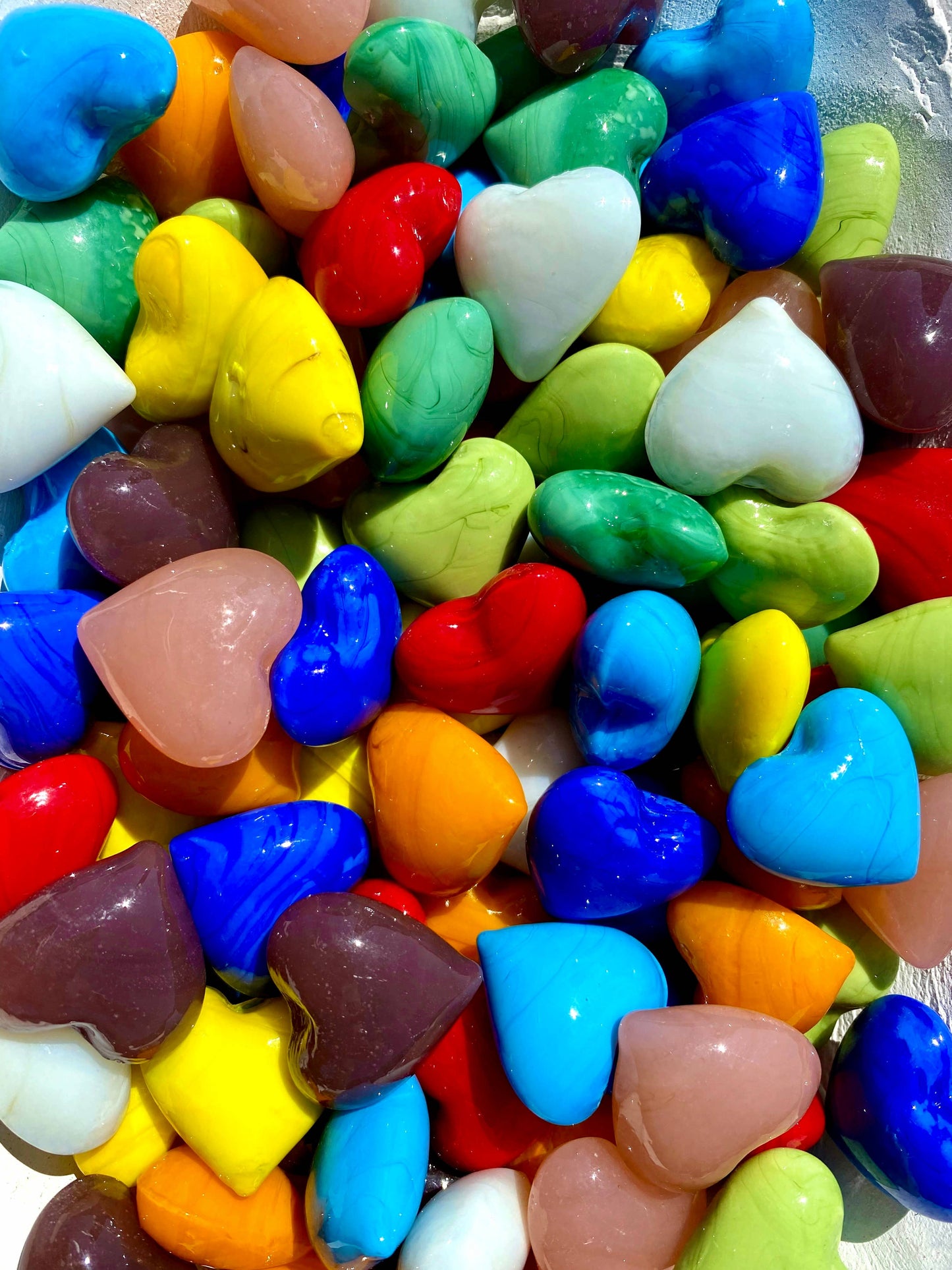 Assorted colorful heart-shaped candies in a pile