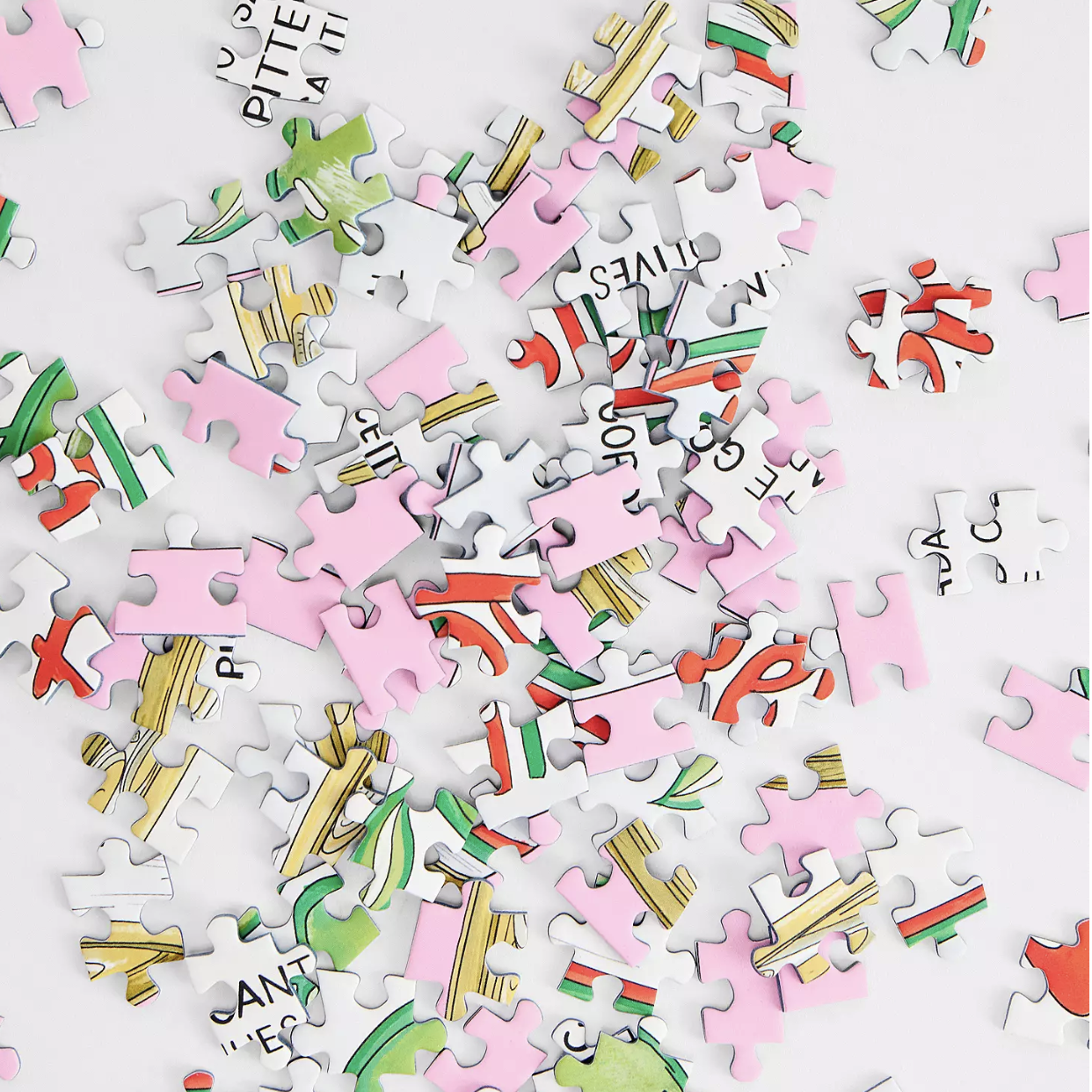 Colorful puzzle pieces with letters and shapes on a white background