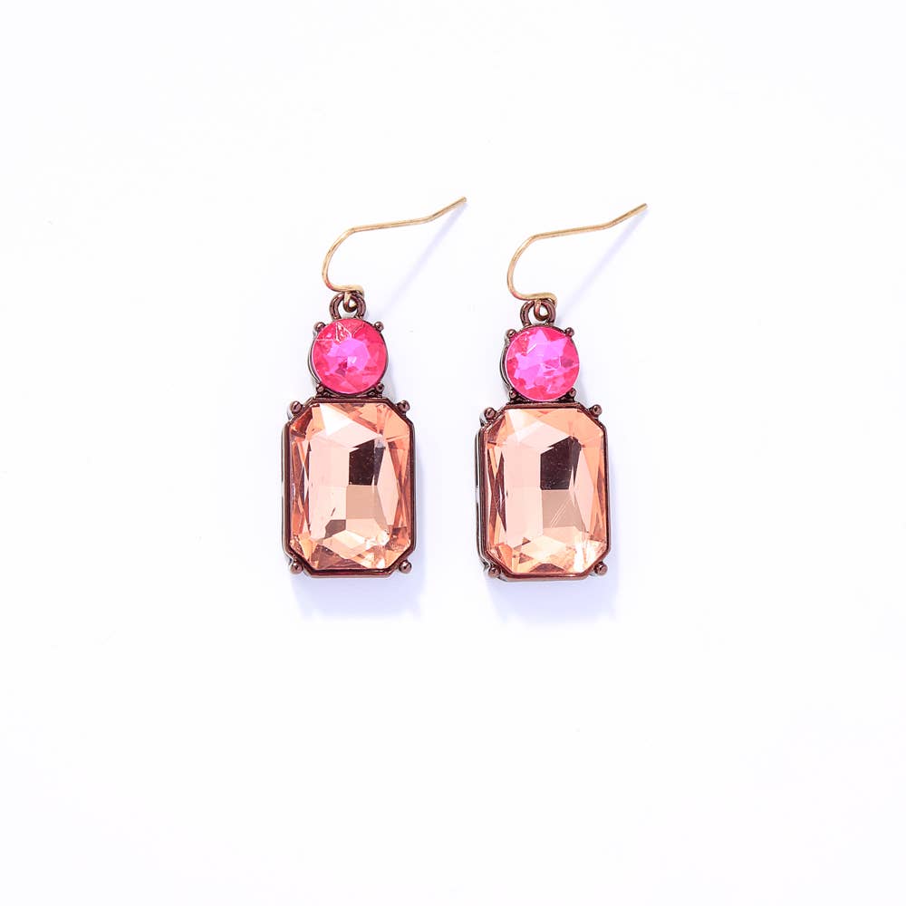 Pair of earrings with pink gemstones on a white background