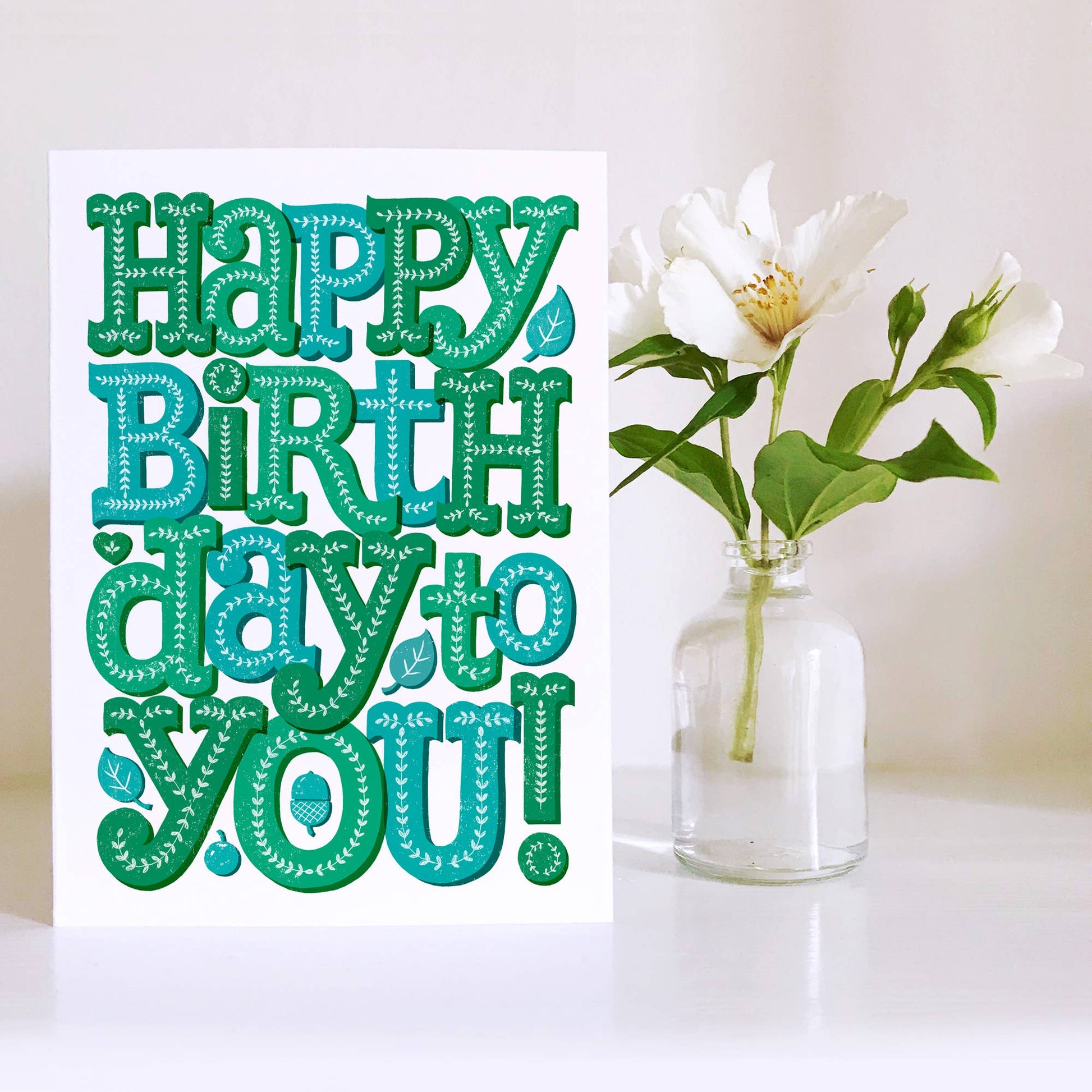 Birthday Card. Blank inside. Decorated text in Green and blue reads Happy Birthday You.