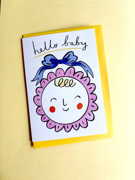 Greeting card with a baby illustration and 'hello baby' text on a yellow background