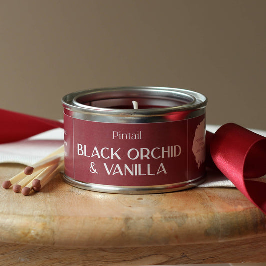Black Orchid & Vanilla candle in a tin.