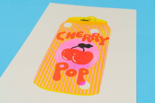 Phone case with cherry design and 'Cherry Pop' text on a blue background