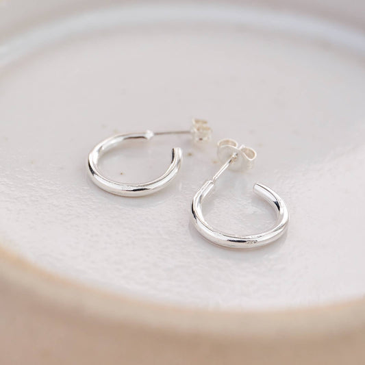 Silver hoop earrings on a light background