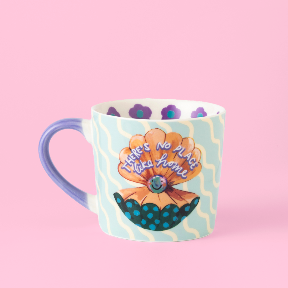 Mug with floral design and text on a pink background