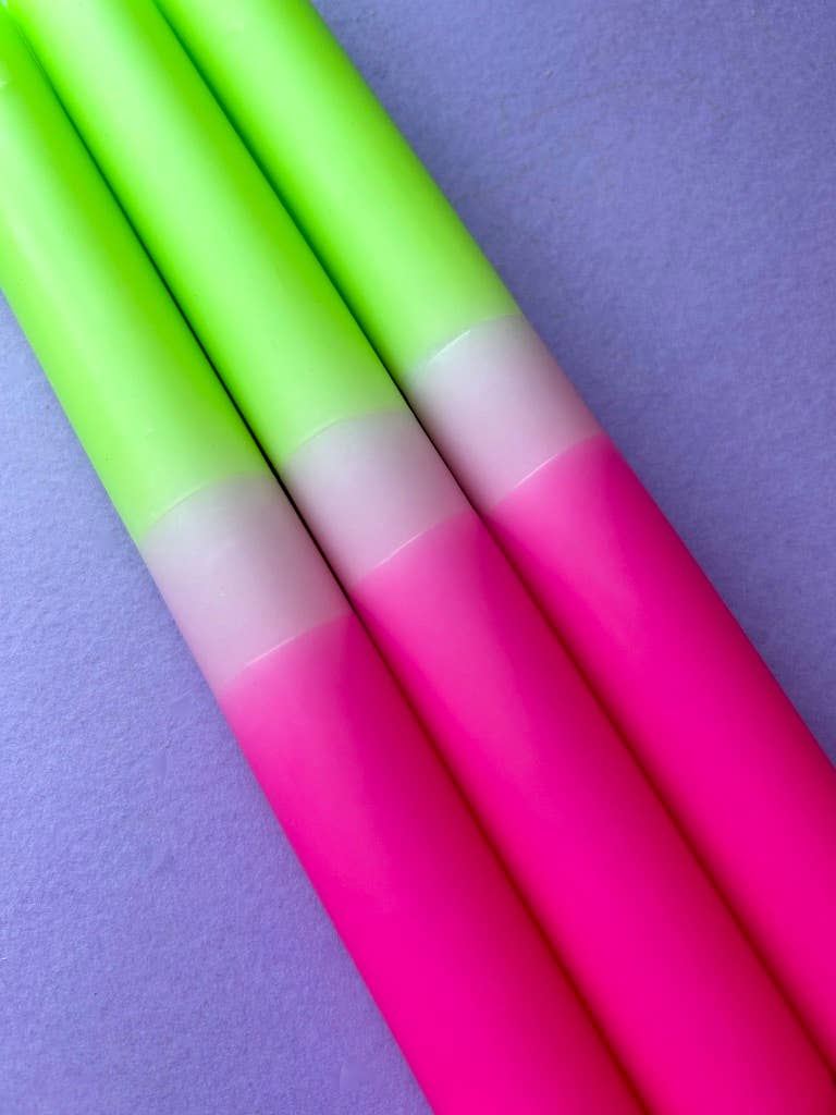 dip dyed candles. bright pink band, pale pink and topped with a lime green.