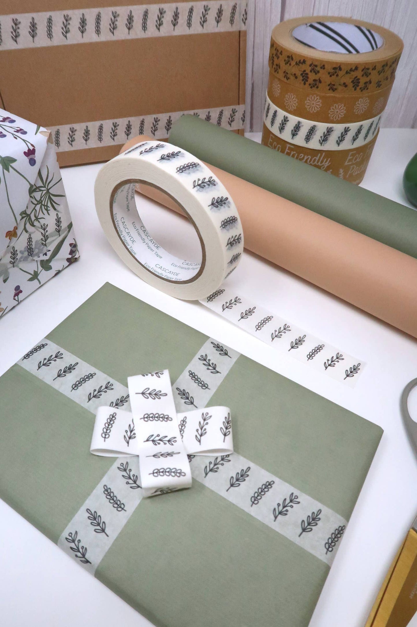 Decorative tape and paper with floral patterns on a white surface