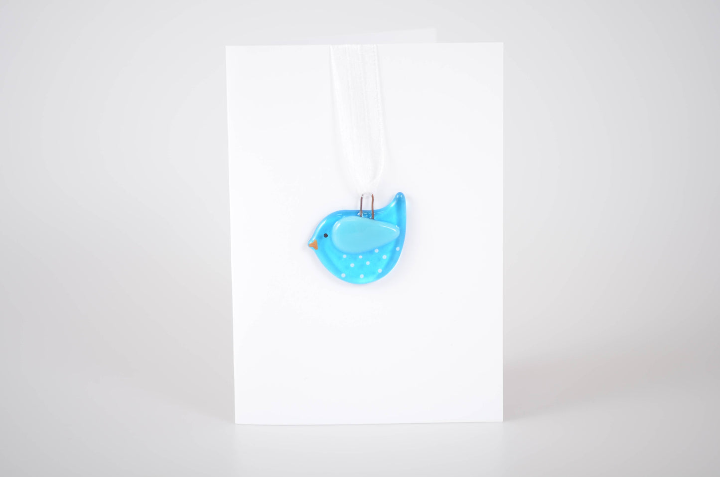 Blue bird-shaped object on a white background