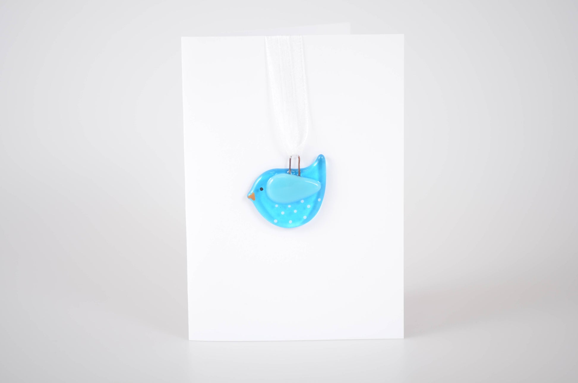 Blue bird-shaped object on a white background