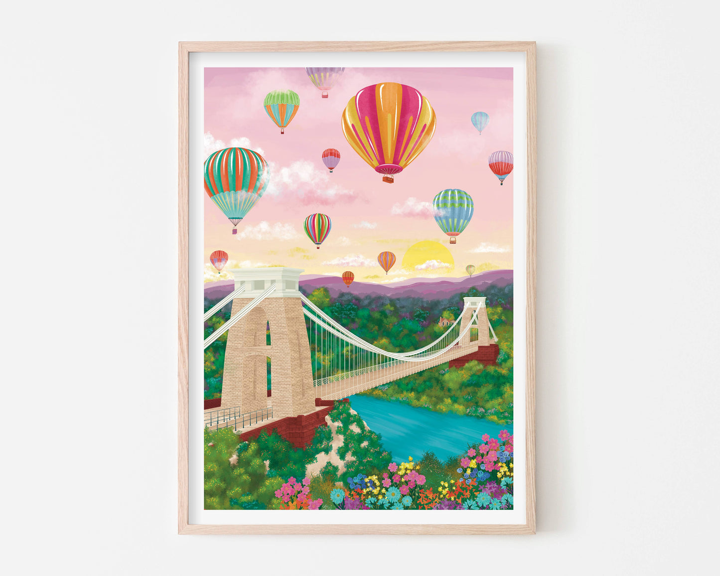 Framed artwork of a bridge with colorful hot air balloons in the sky.