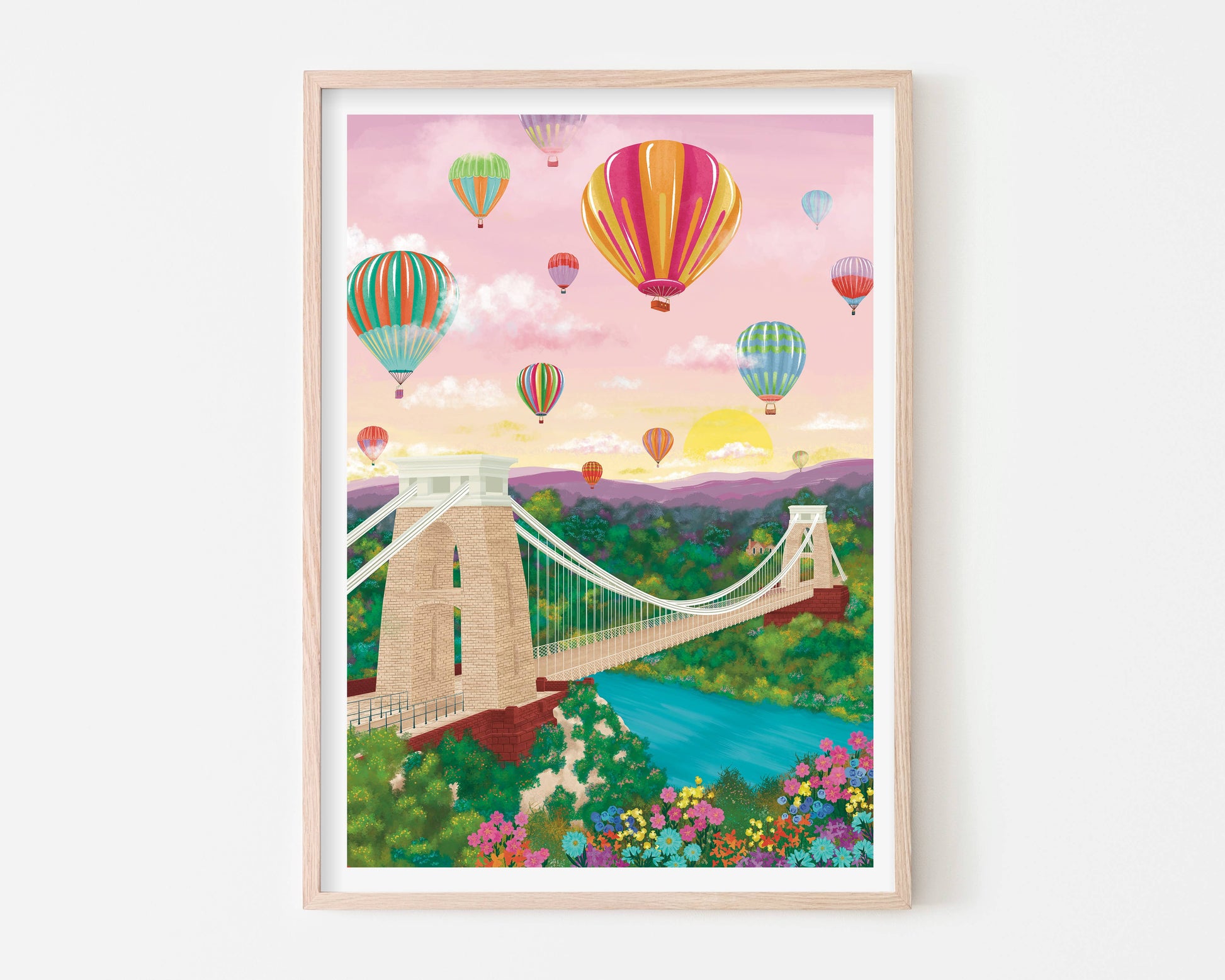 Framed artwork of a bridge with colorful hot air balloons in the sky.