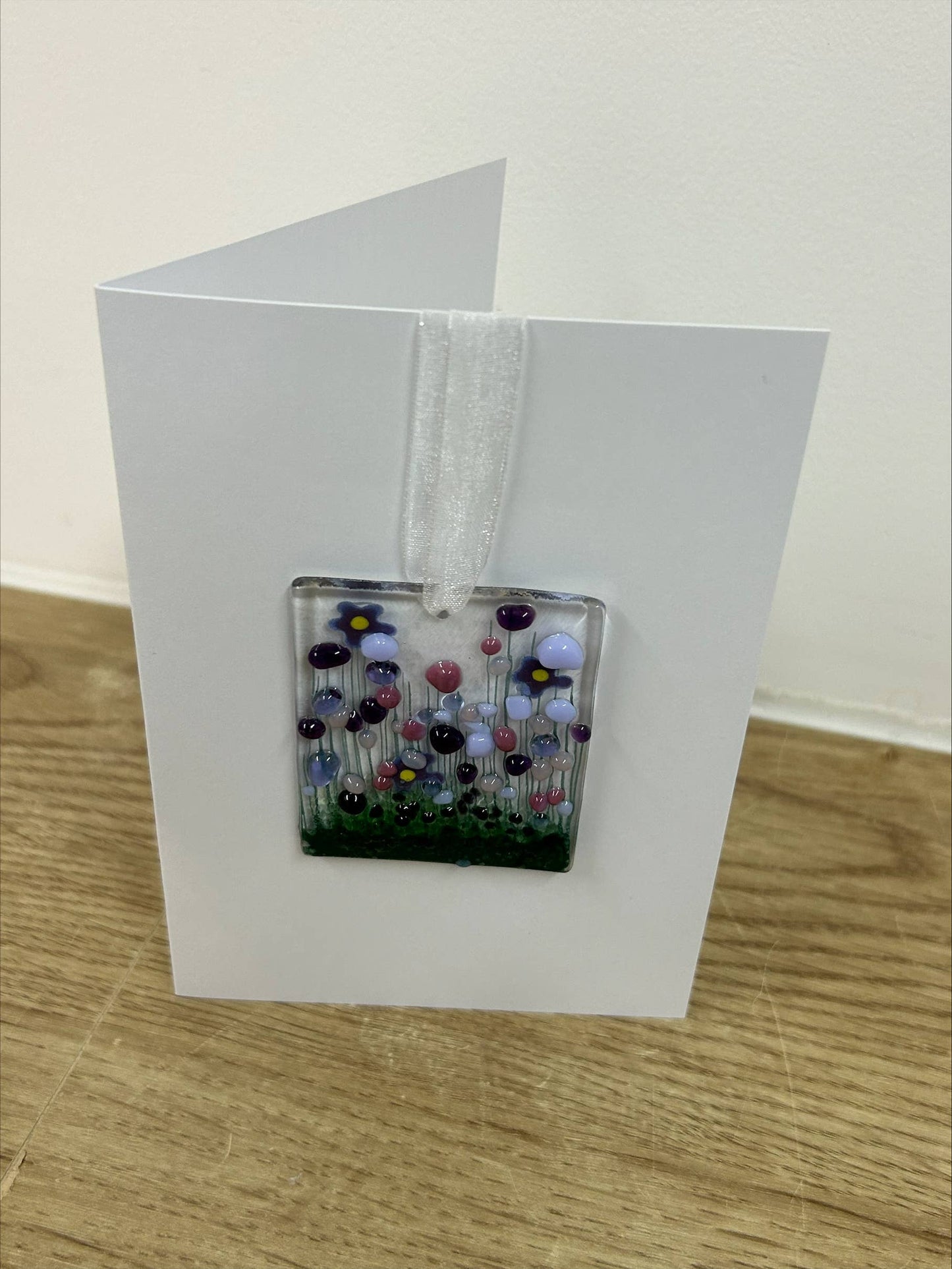 Greeting card with a floral design on a wooden surface
