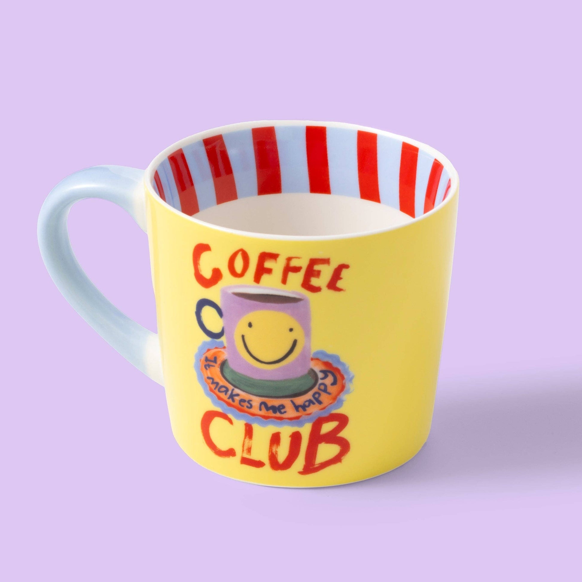 Yellow mug with red and blue striped interior, featuring a smiley face and text on a purple background.