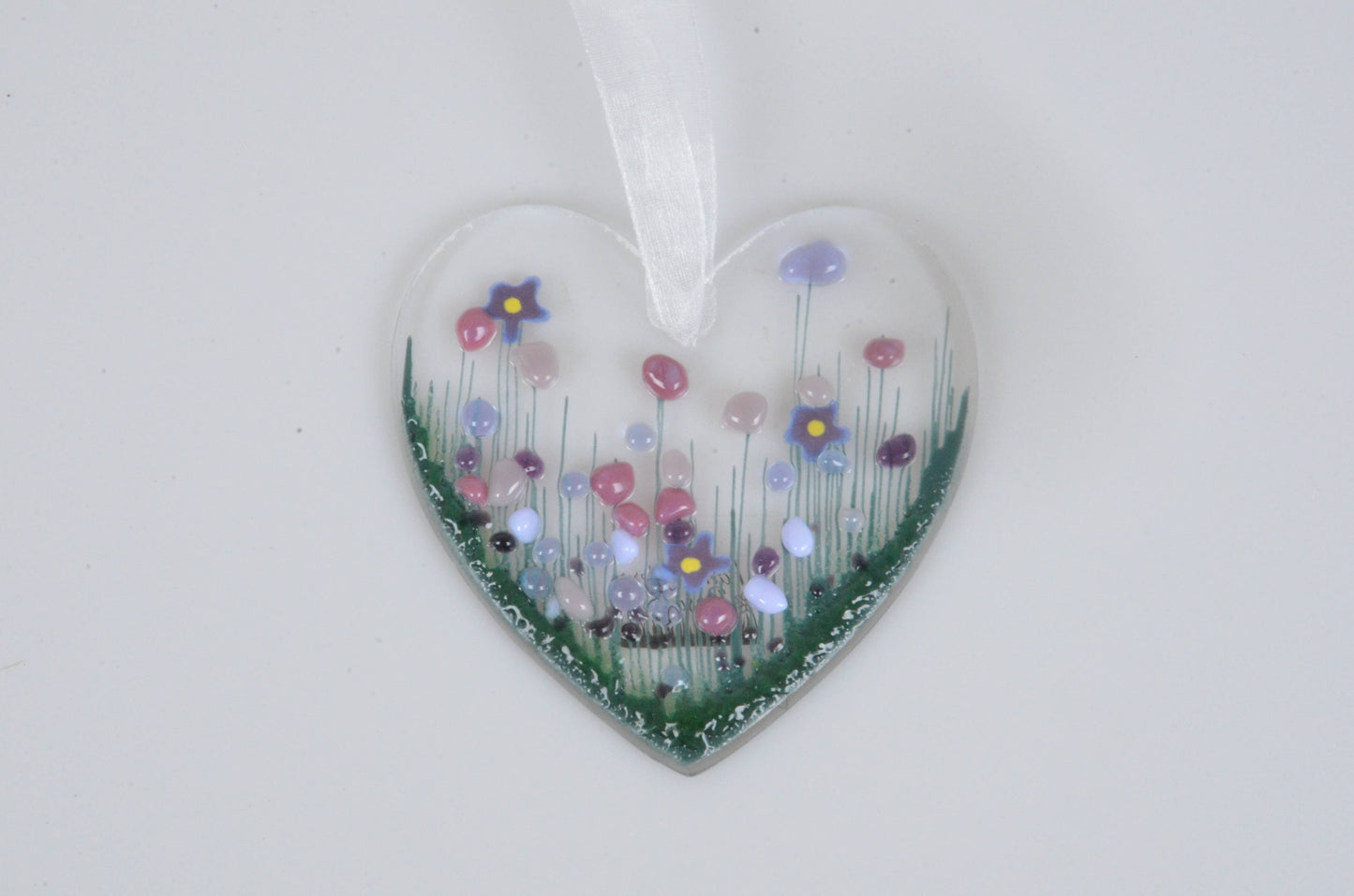 Heart-shaped ornament with floral design on a white background