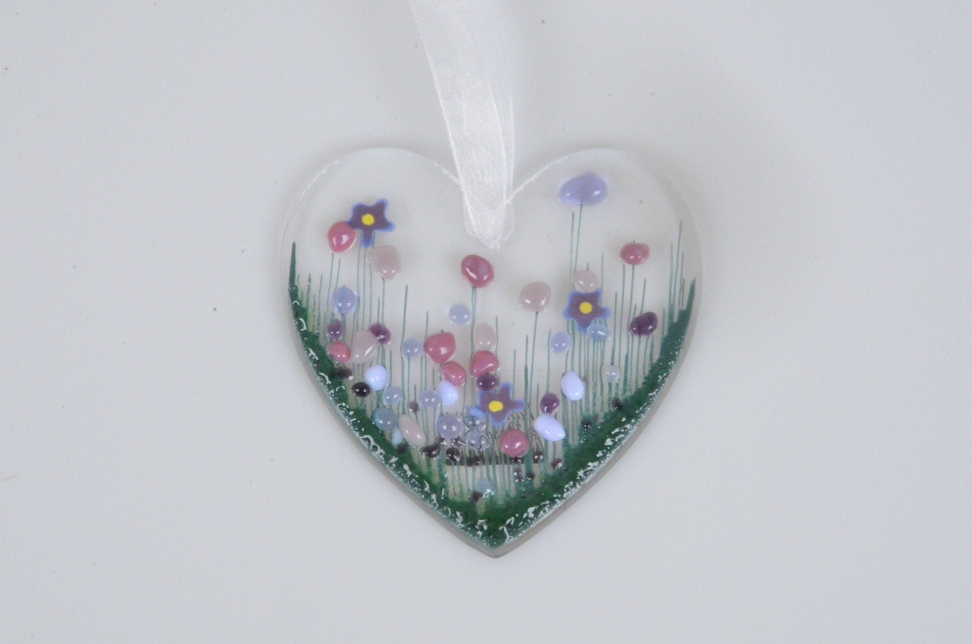 Heart-shaped ornament with floral design on a white background
