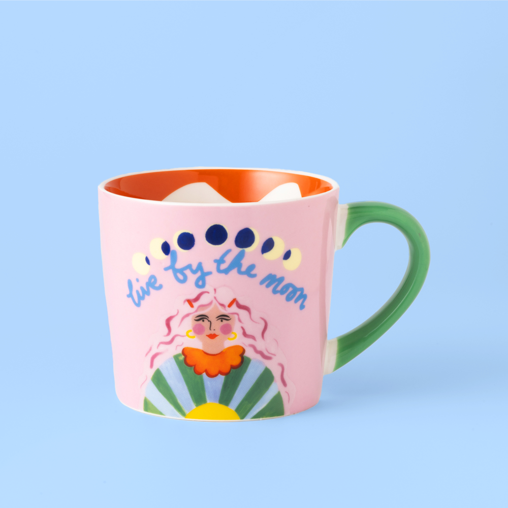Colorful mug with artistic design and text on a light blue background