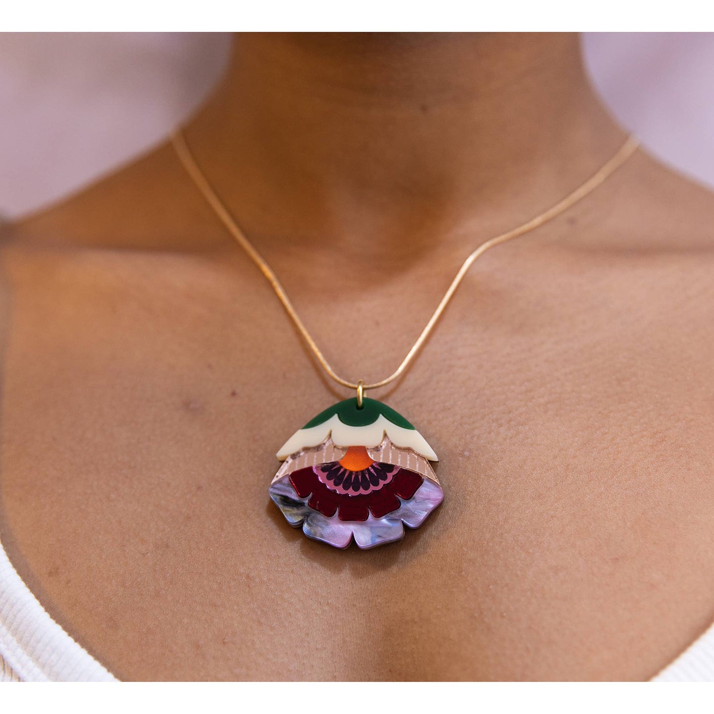 Necklace with a colorful pendant on a person's neck